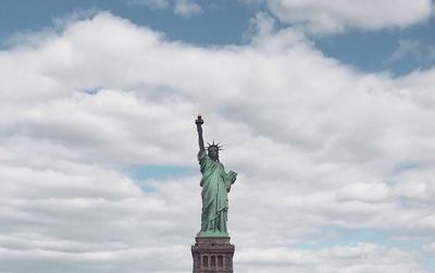 Low angle view of statue against cloudy sky