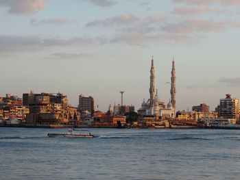  suez canal by buildings against sky in city