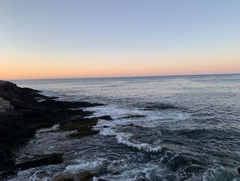 Scenic view of sea against clear sky during sunset