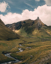 Scenic view of mountains against cloudy sky