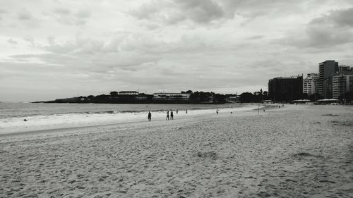 View of beach against cloudy sky