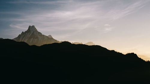 Scenic view of silhouette mountains against sky