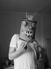 Midsection of man holding woman standing against wall