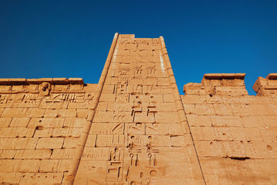 Low angle view of a temple against clear blue sky