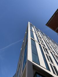Low angle view of modern building against clear blue sky