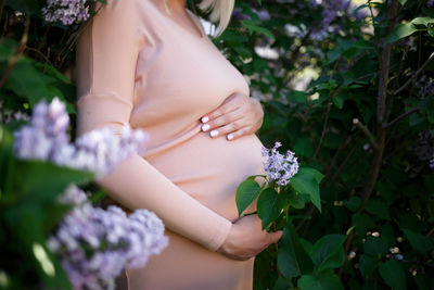 Midsection of woman holding flower bouquet