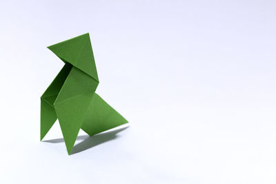 High angle view of green paper against white background