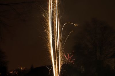 Low angle view of firework display at night