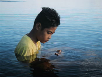 Thoughtful boy in lake