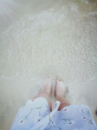 Low section of man relaxing on beach