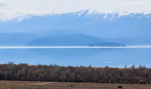 Scenic view of calm lake against mountain range