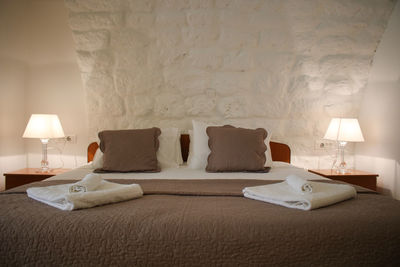 Table and chairs on bed against wall at home