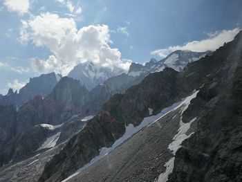 Scenic view of mountains against cloudy sky