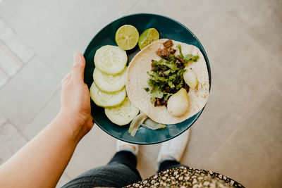 Cropped hand of person holding food on table