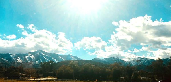 Scenic view of mountains against sky on sunny day