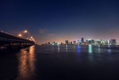 Illuminated city at waterfront