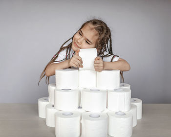 Portrait of smiling girl sitting against wall