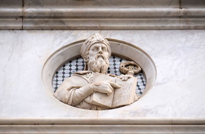 Low angle view of angel statue on wall