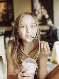 Portrait of girl having coffee while sitting in cafe