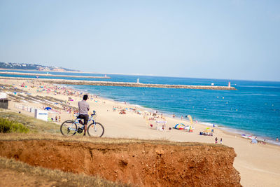 Bicycles on beach against clear sky