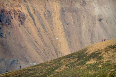 Scenic view of plane against mountain