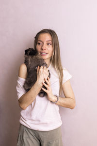 Portrait of smiling young woman holding cat