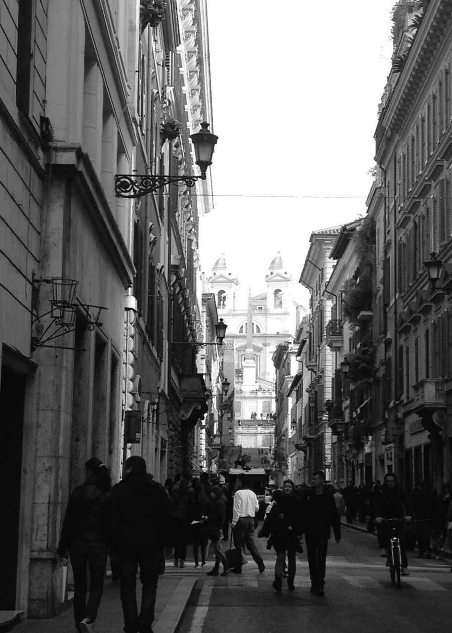 building exterior, architecture, built structure, men, person, walking, large group of people, city, street, lifestyles, city life, leisure activity, city street, mixed age range, group of people, sky, building, road, rear view