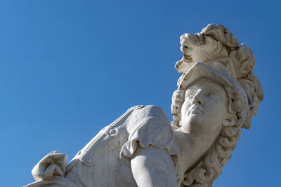 Low angle view of statue against blue sky