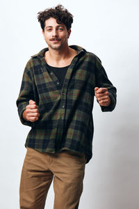 Portrait of young man standing against clear sky