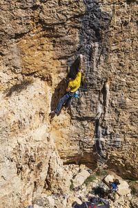 View of man rock climbing