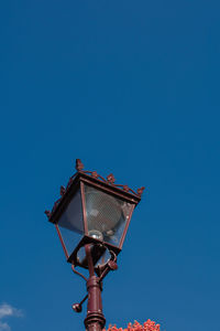 Low angle view of street light against clear blue sky