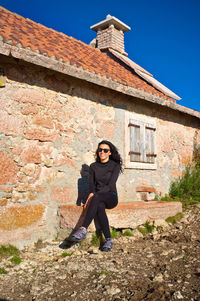 Side view of woman standing on mountain