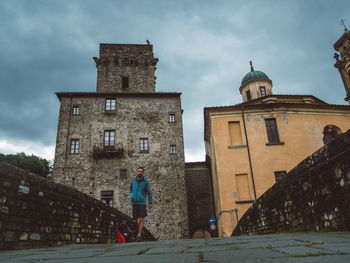 Low angle view of church and buildings against sky