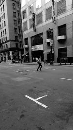 Man walking on road in city