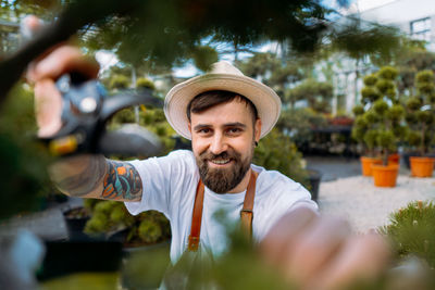 Portrait of senior man wearing hat while standing outdoors