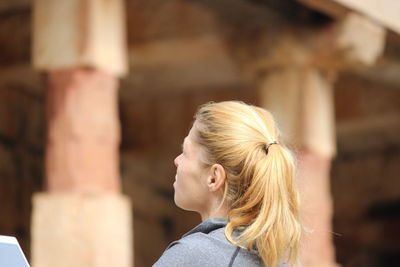 Side view of young woman against blurred background