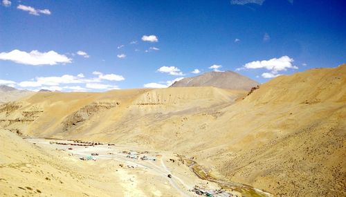 Scenic view of desert against blue sky