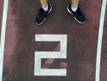 Low section of man standing on floor