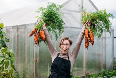 Rear view of woman standing by plants