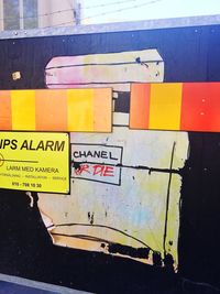 Close-up of arrow sign on city