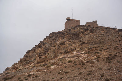 Low angle view of fort on mountain against sky