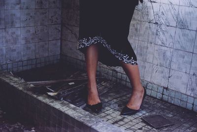 Low section of woman standing on tiled floor