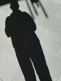 Shadow of person on tiled floor