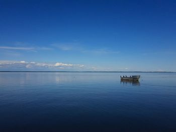 Scenic view of sea against blue sky