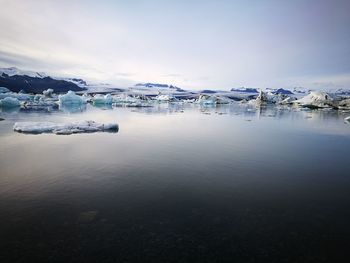 Scenic view of frozen lake against sky