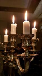 Close-up of silver chandelier with burning candels on table