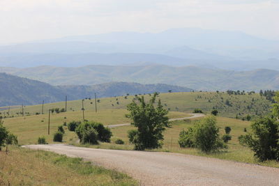 Scenic view of landscape and mountains against sky