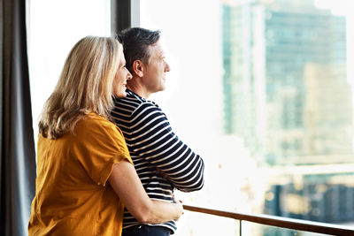 Mature couple embracing in balcony