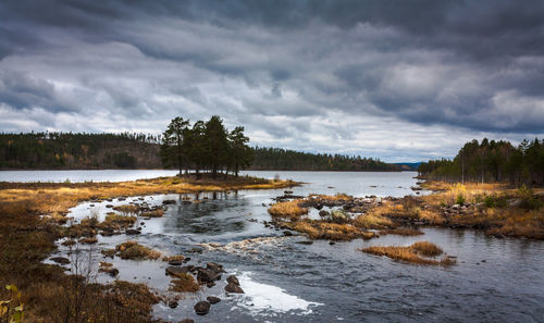 Scenic view of lake against cloudy sky