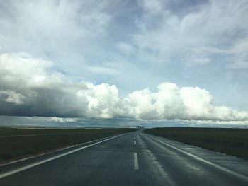 Road by sea against storm clouds